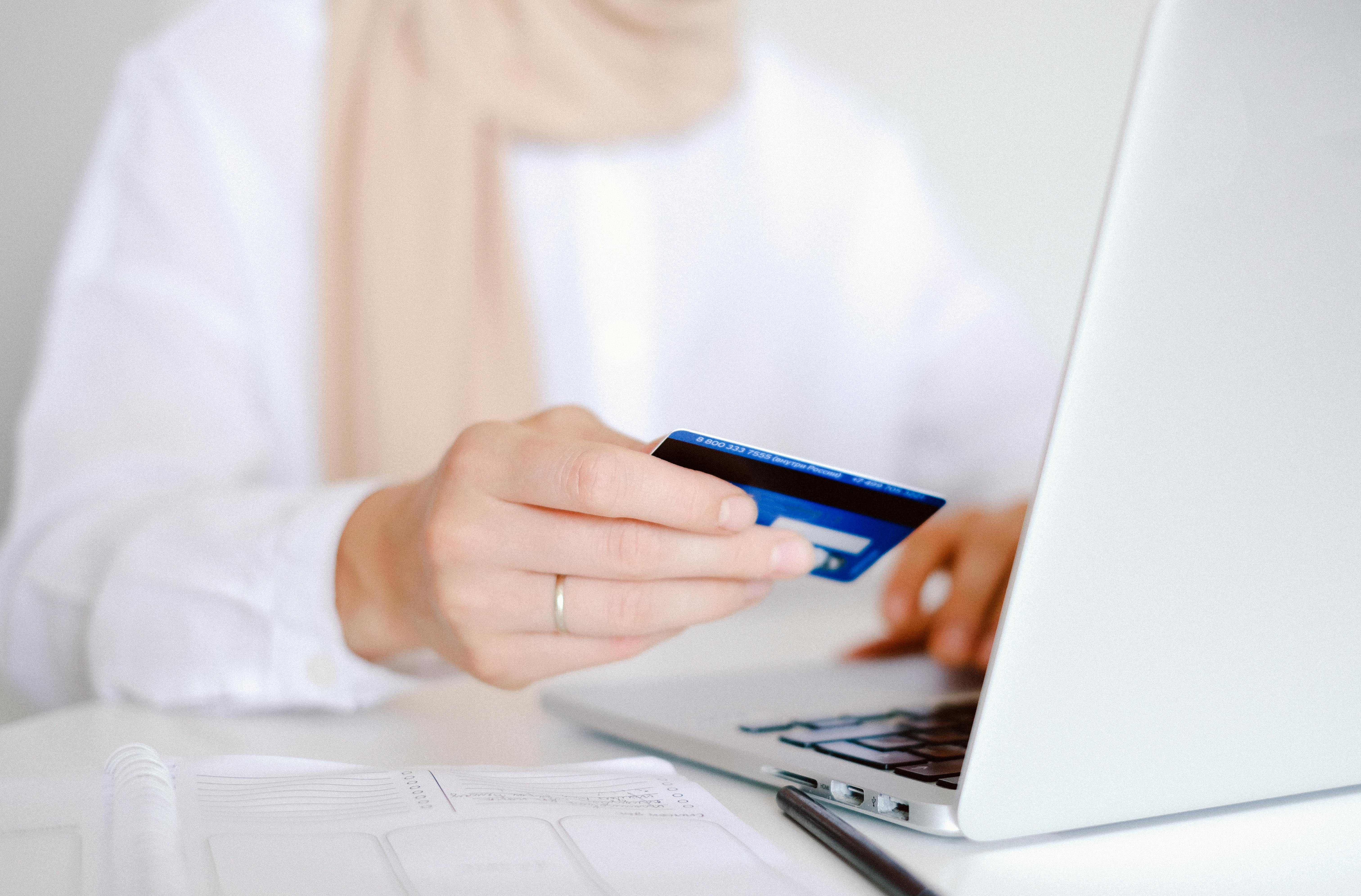 Photo by Anna Shvets: person-in-white-long-sleeve-shirt-holding-credit-card